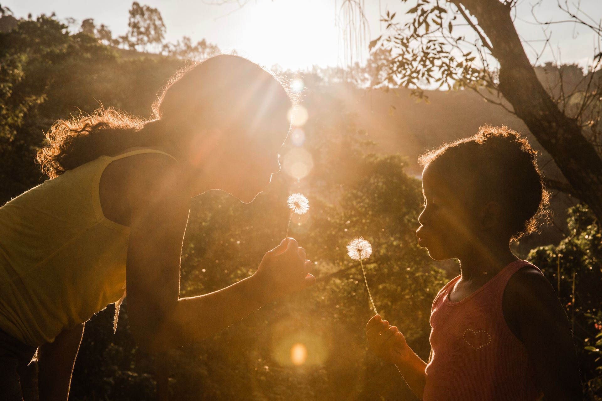 A man is kissing a woman on the cheek while holding a baby.