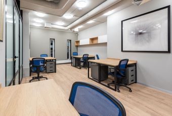 A room with a lot of desks and chairs in it.