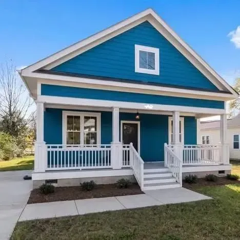 A blue house with a white porch and stairs