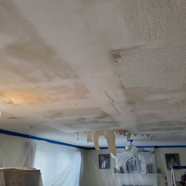 A room with a ceiling that is being painted.