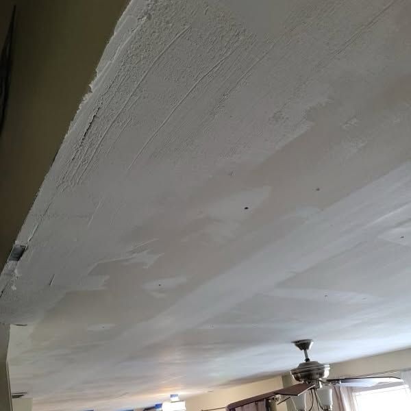 A white ceiling with a ceiling fan in a living room.