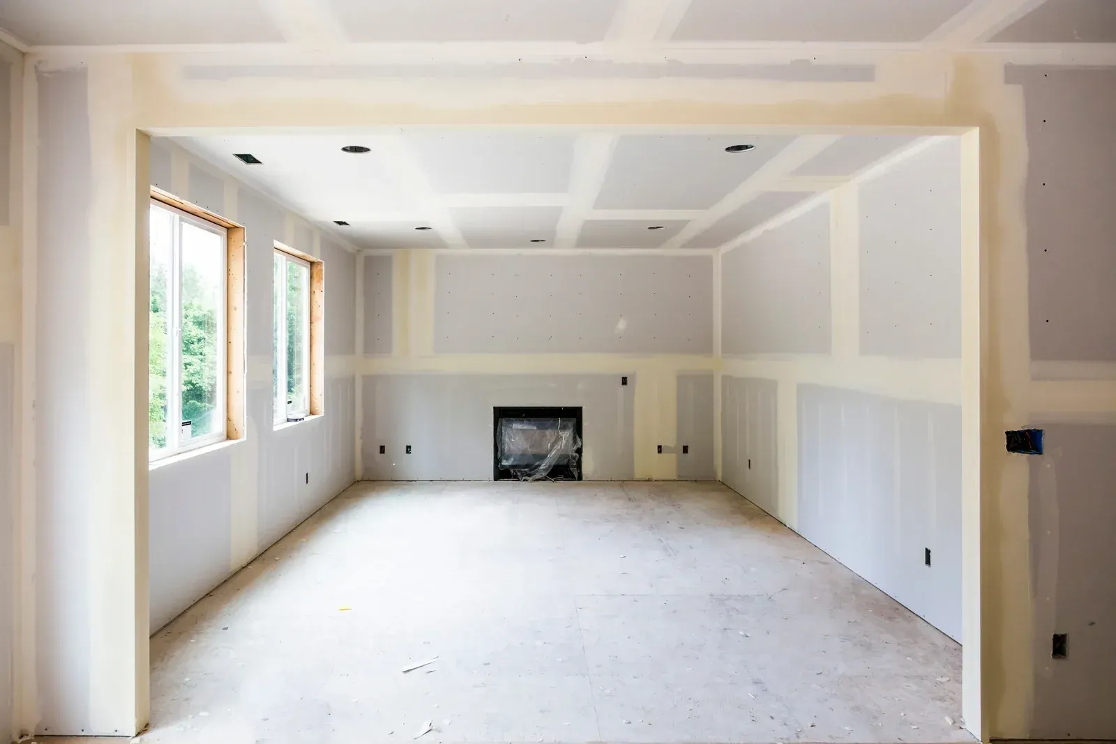 An empty room with a fireplace in the middle of it