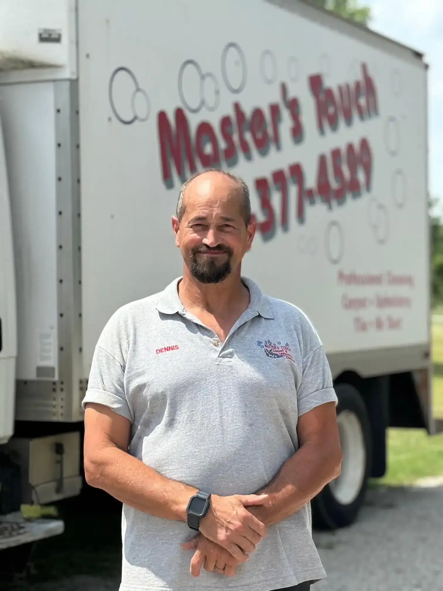Man in gray shirt stands in front of a truck for Man in gray shirt stands in front of a truck for