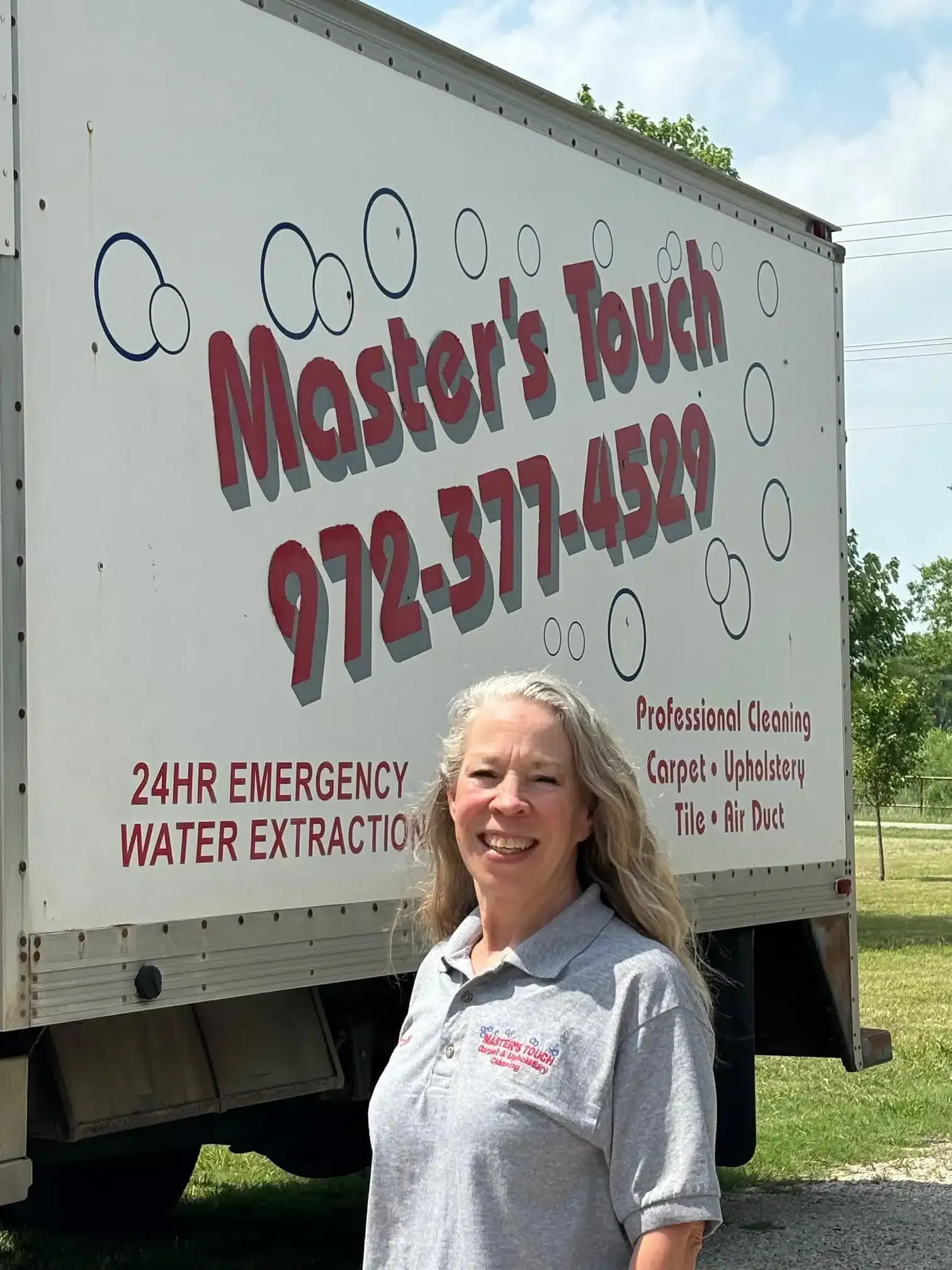 Woman standing in front of a truck with Woman standing in front of a truck with