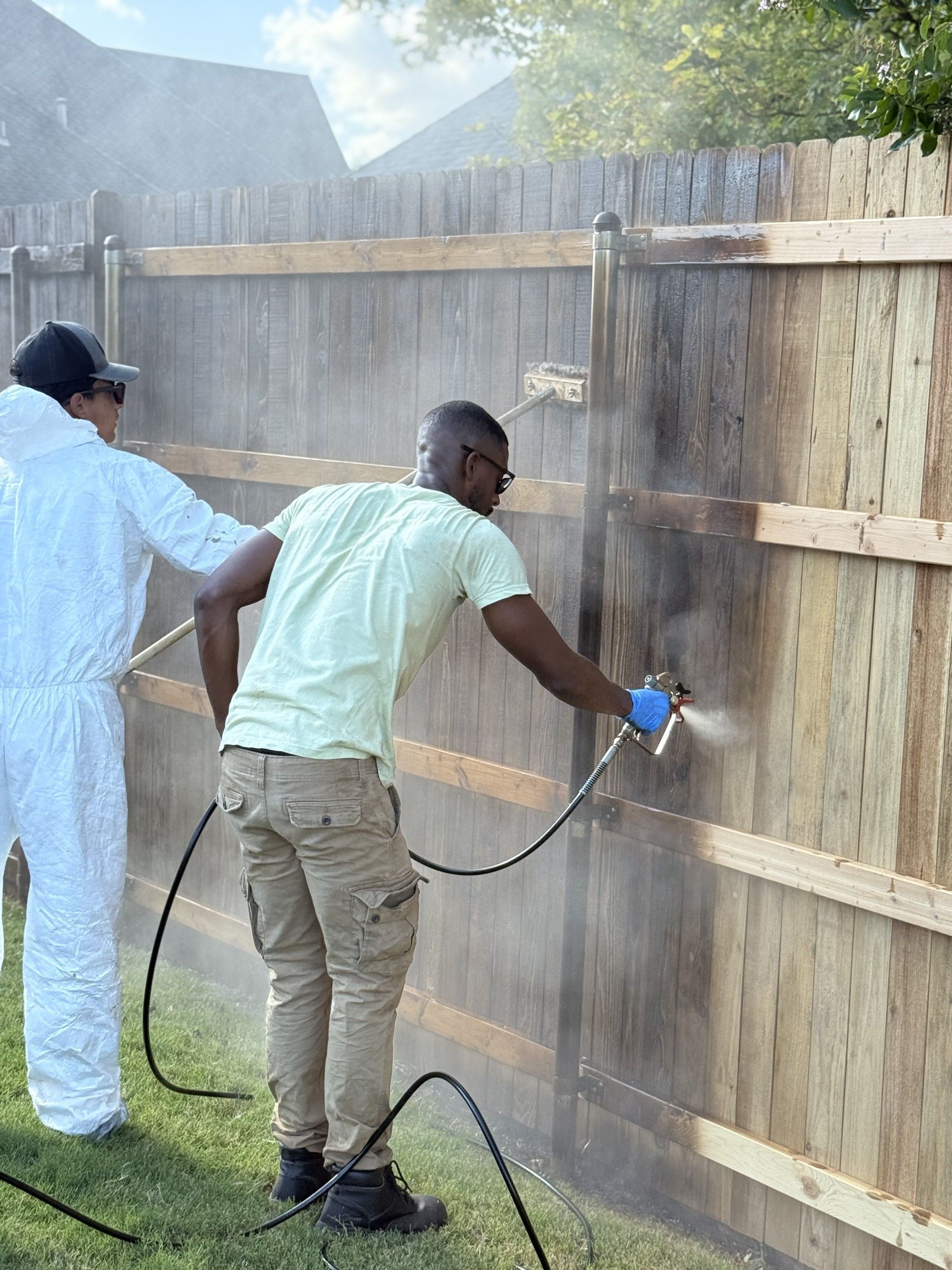 Two men are installing a fence.
