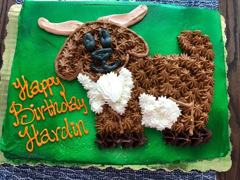 A birthday cake with a picture of a goat on it