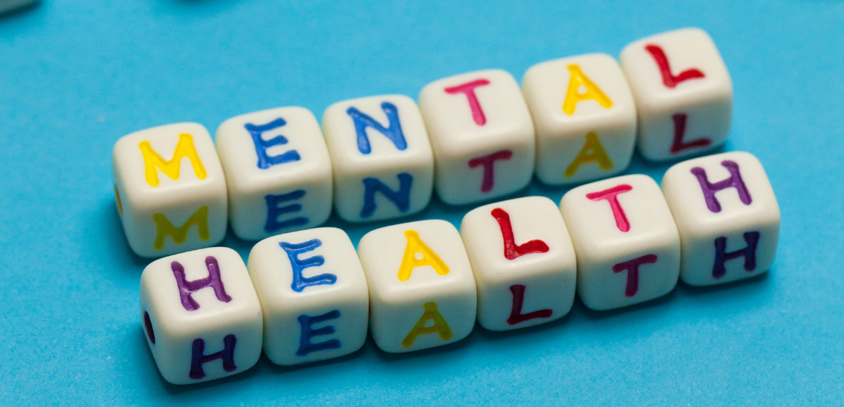Colorful letter cubes on a blue background spelling 