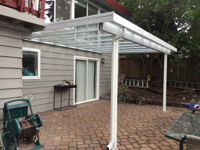 A Patio With A Glass Roof — Kirkland, WA — Action Installations LLC