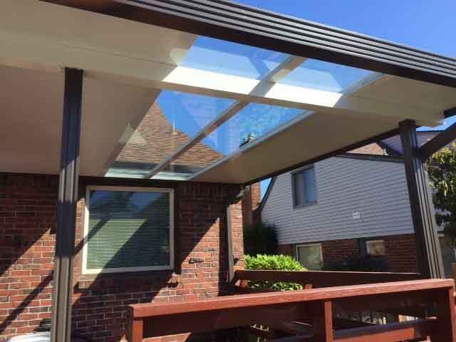 A Brick House With A Glass Roof And A Wooden Deck — Kirkland, WA — Action Installations LLC