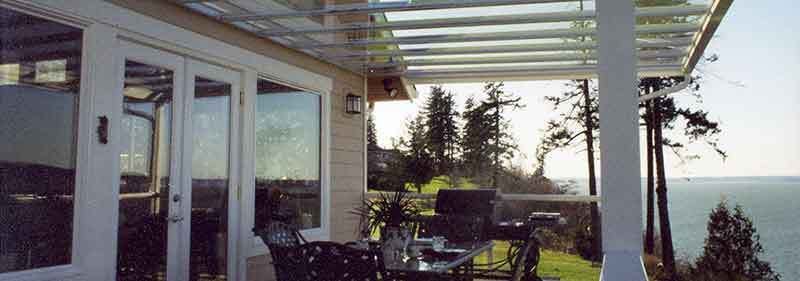 A Patio With A Table And Chairs And A View Of The Ocean — Kirkland, WA — Action Installations LLC