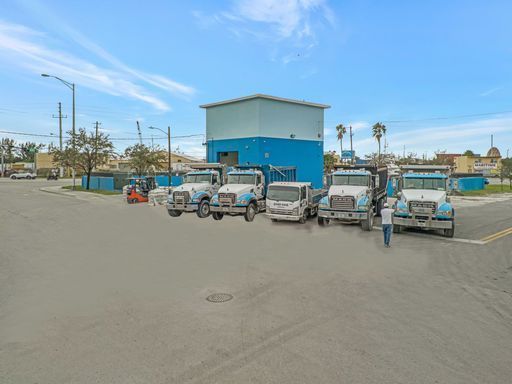 A row of trucks are parked in front of a building.