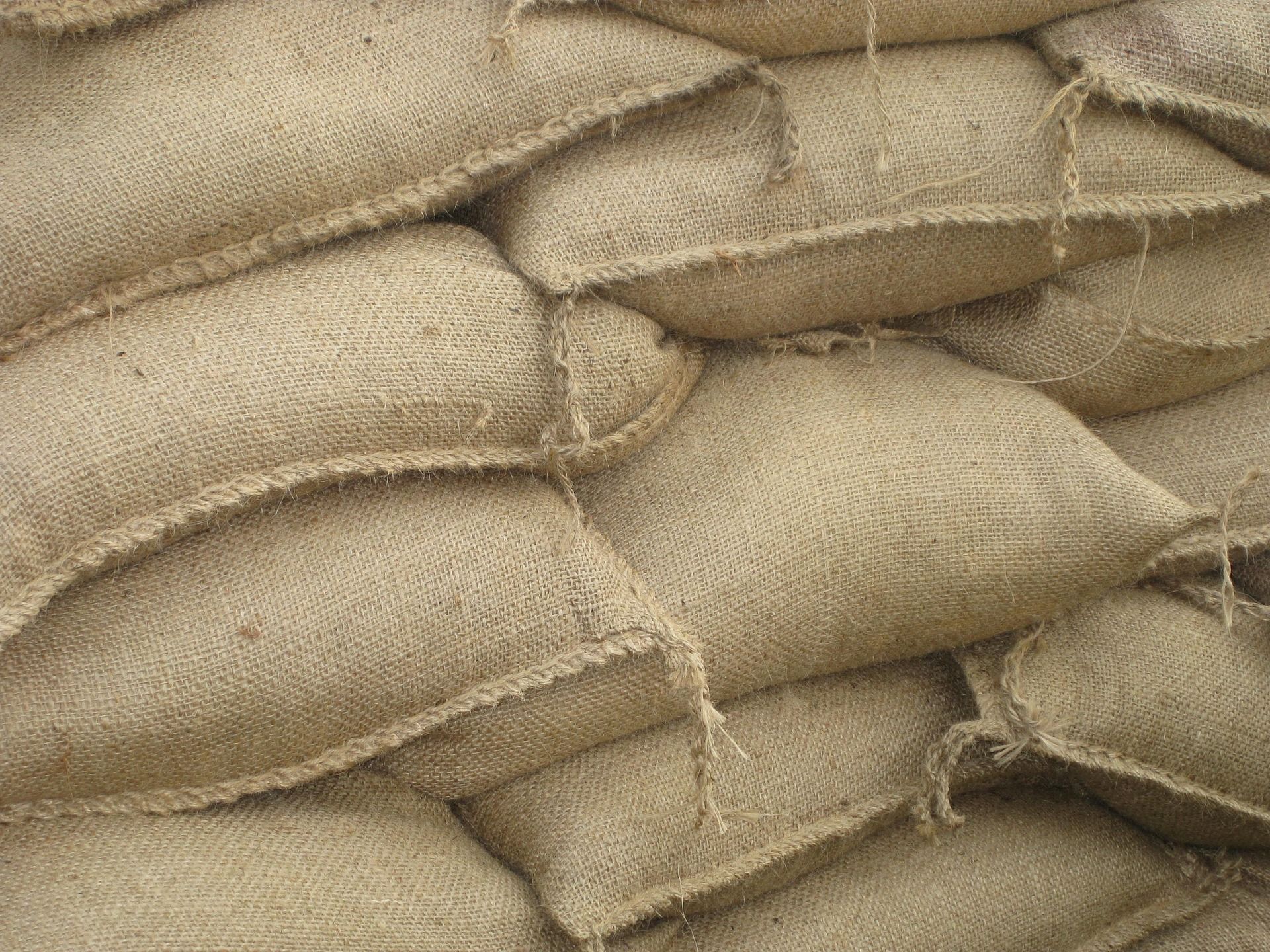 A pile of burlap sacks stacked on top of each other.