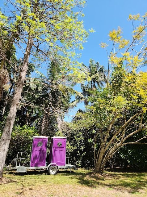 Two Purple Portable Toilets on a Trailer — Royal Flush Luxury Toilet, Portaloo & Shower Hire in Gympie, QLD