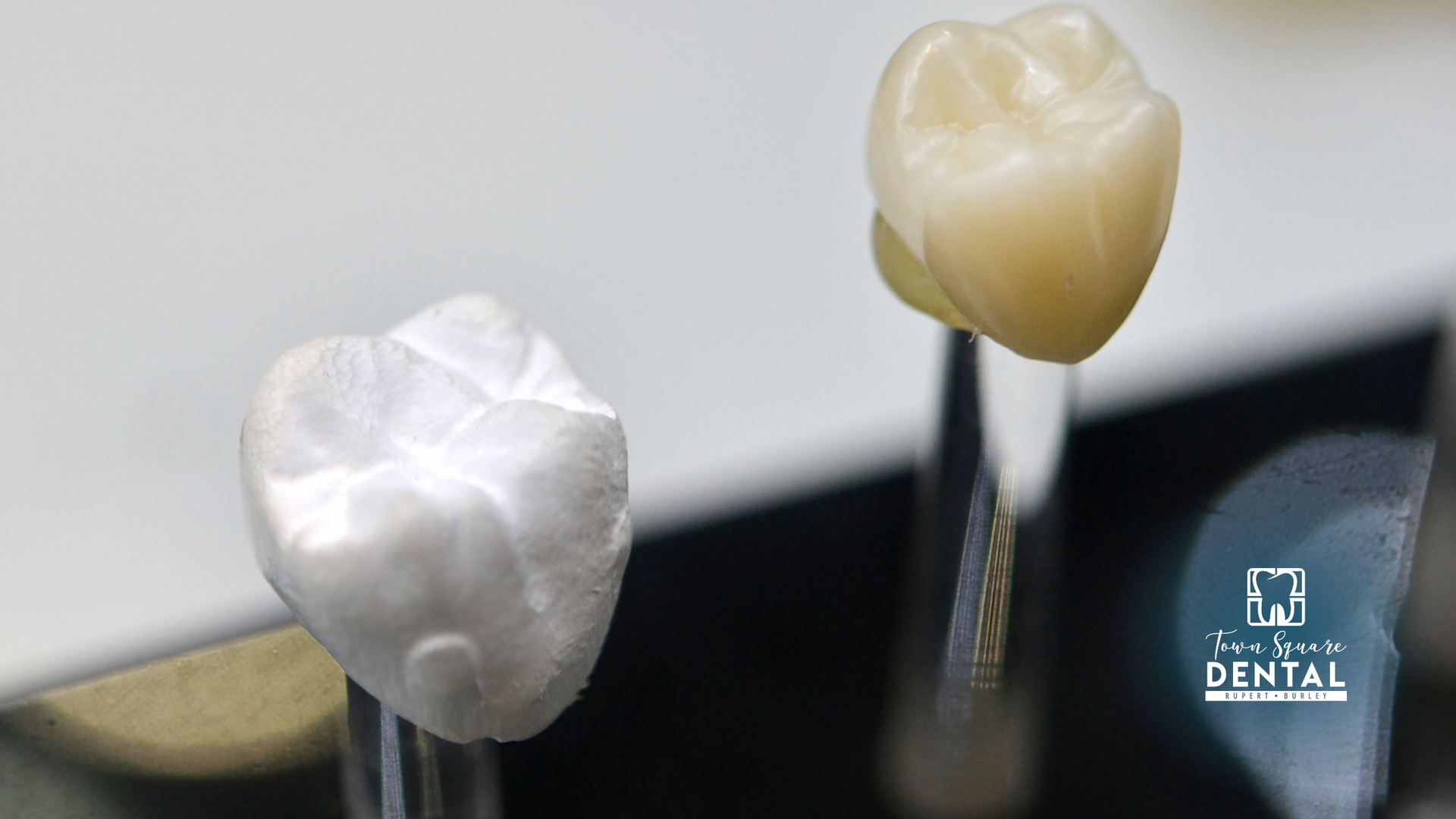 A close up of two dental crowns on a table