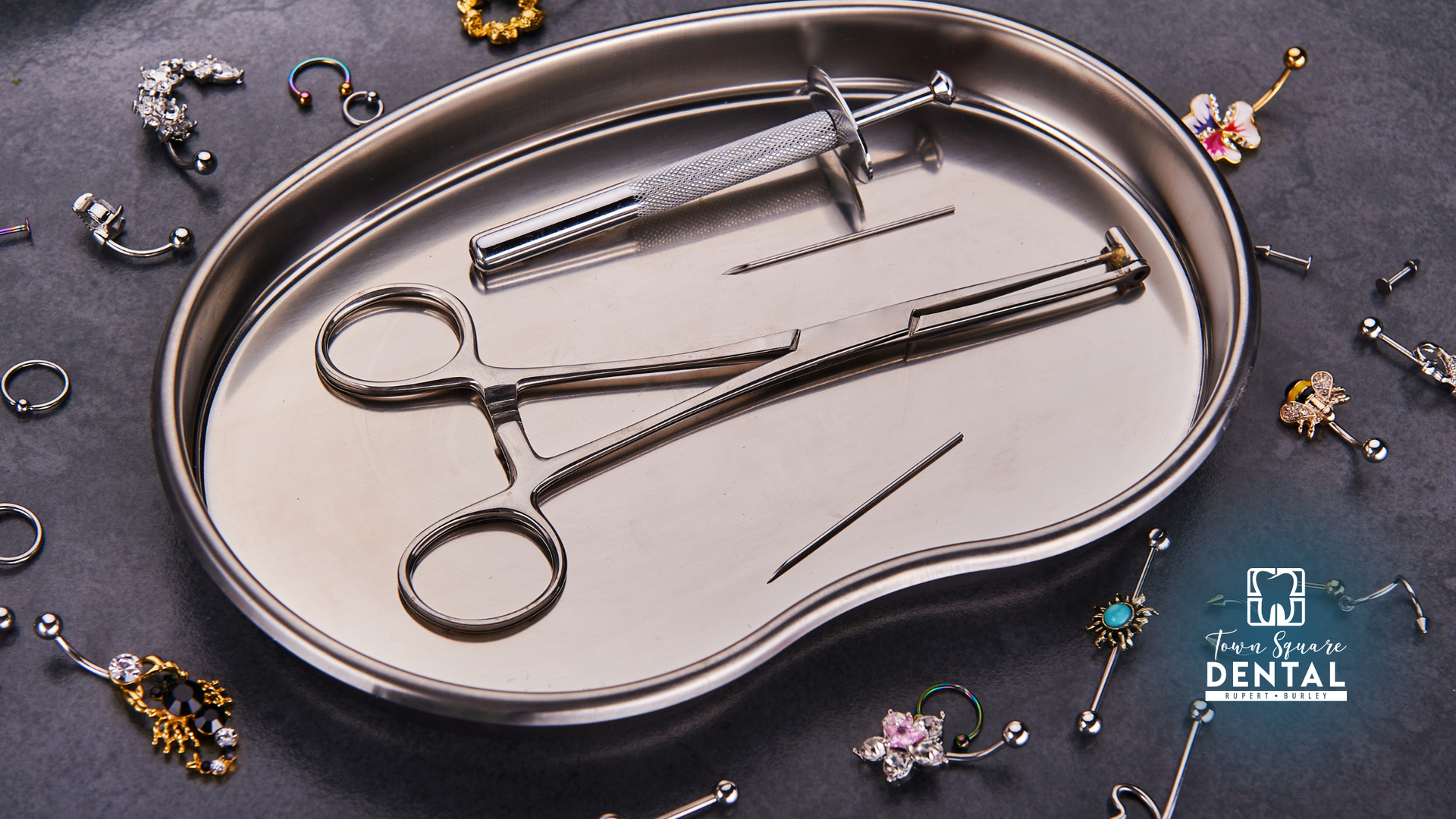 A kidney shaped tray filled with dental instruments