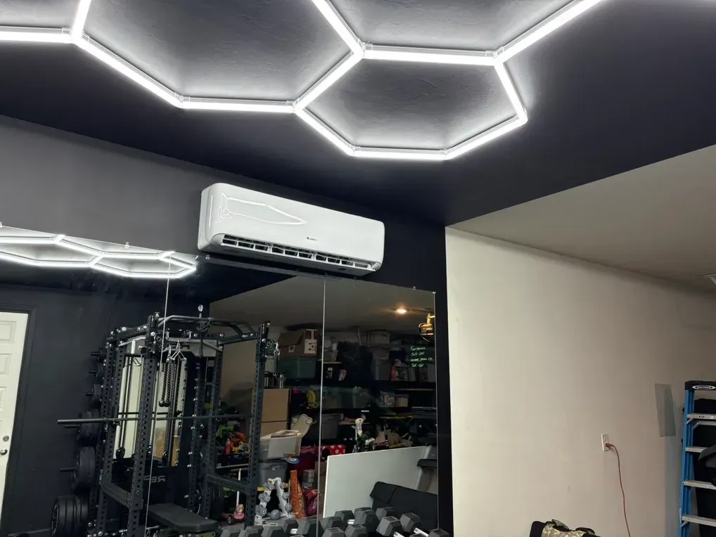 A room with a ceiling fan and a mirror.