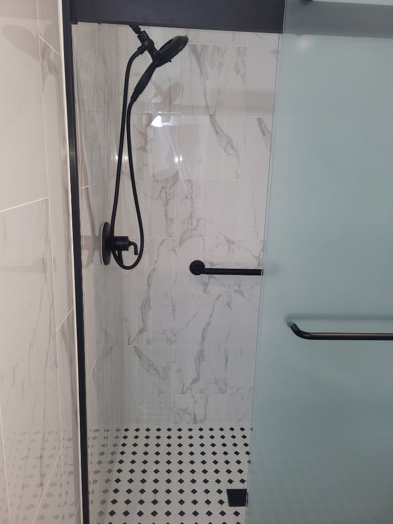 A red garbage disposal is sitting under a sink.