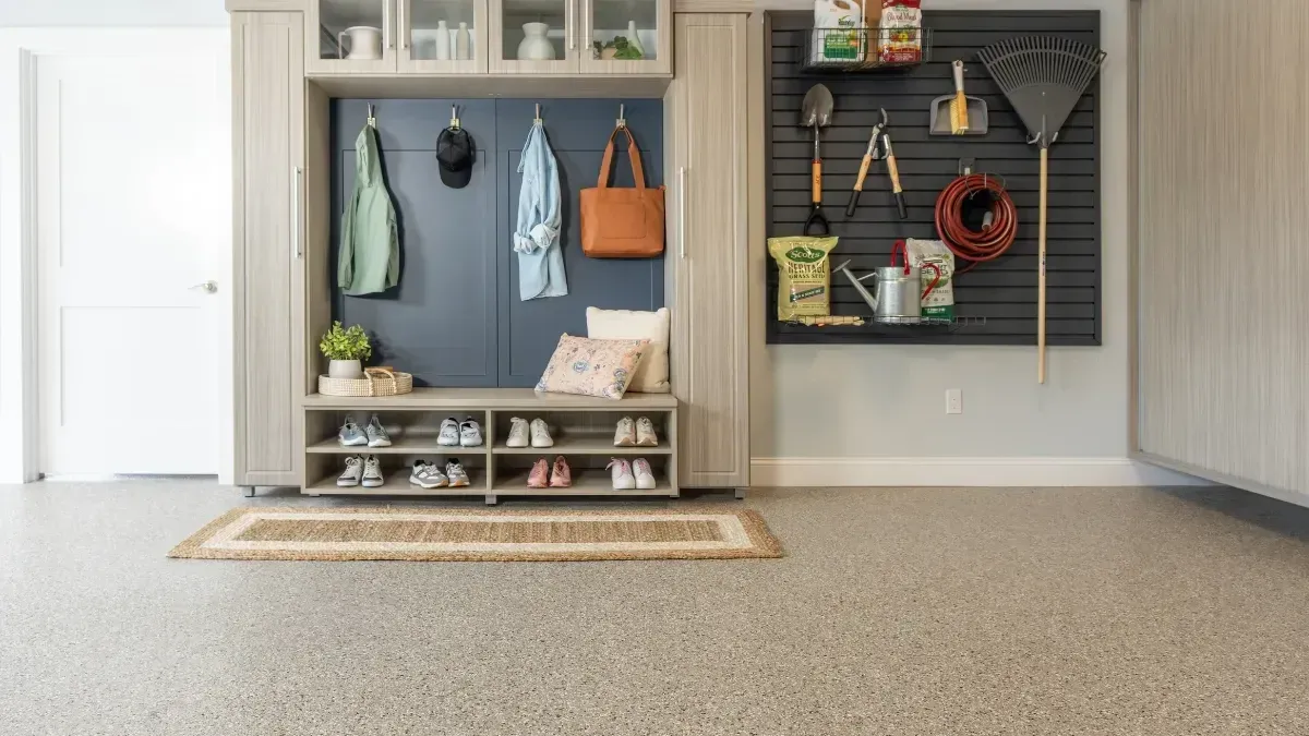 Modern entryway with grey tile floors, wooden accents, and a blue cabinet with plants.