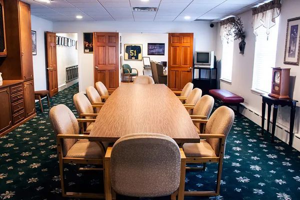 A conference room with a long table and chairs