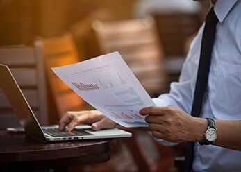 Businessman Looking At Figures — Taxation services in Buderim, QLD