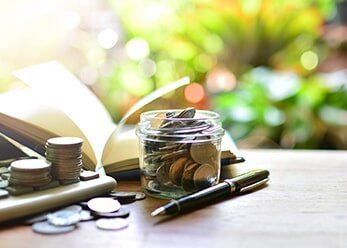 Coins On A Table & Jar — Taxation services in Buderim, QLD