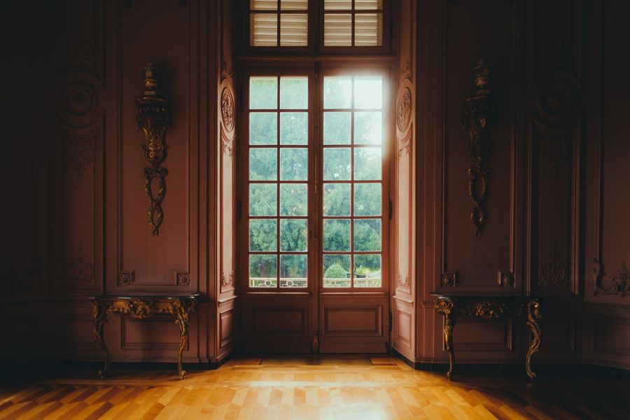 The sun is shining through the window of an empty room.