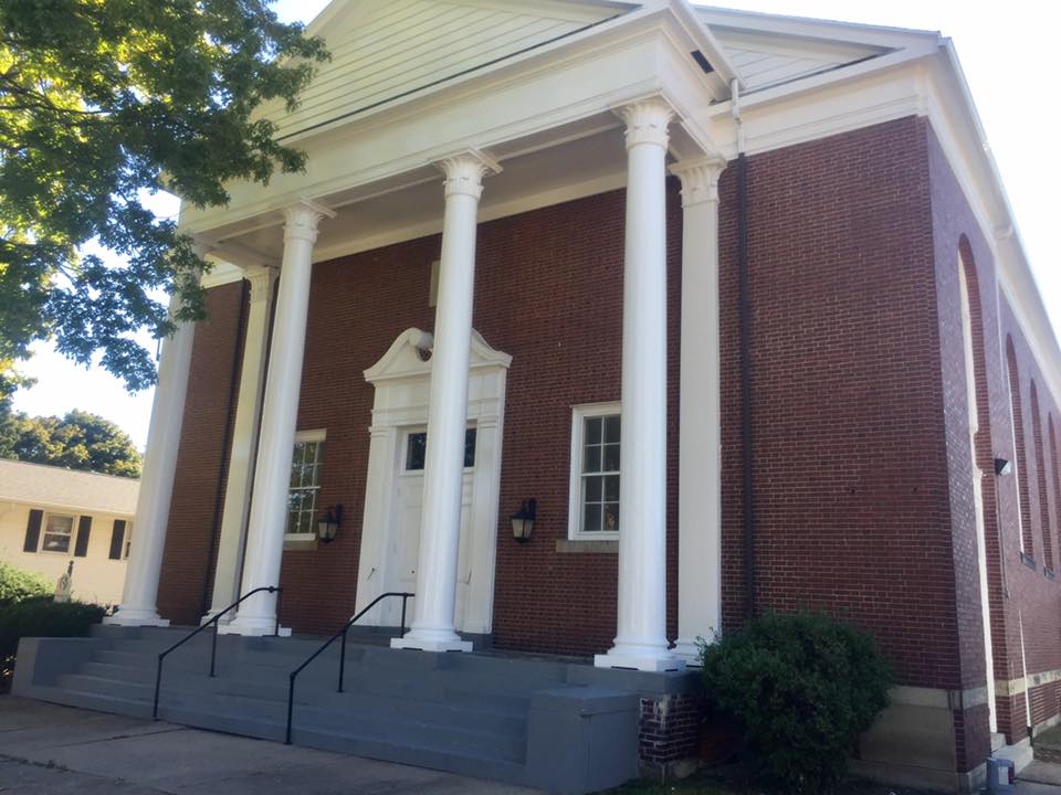 decorative columns in front of brick building