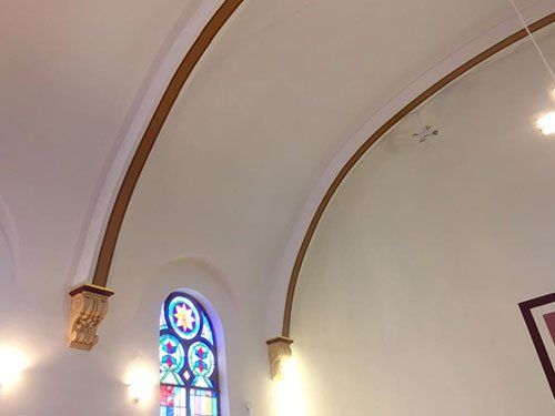 arches above stained-glass window in church