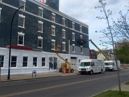 restoration crew at work on side of building