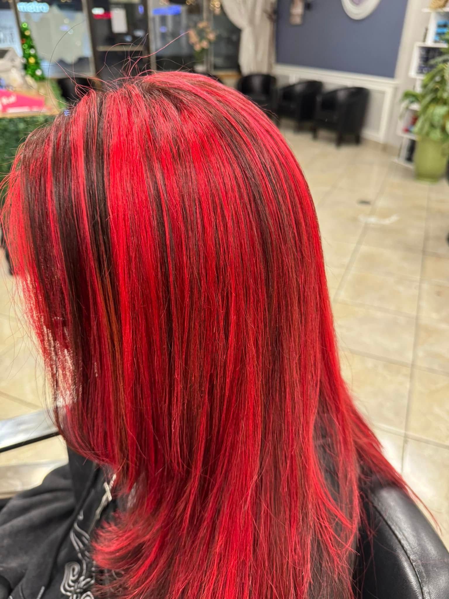 Woman with red and black hair in a salon.