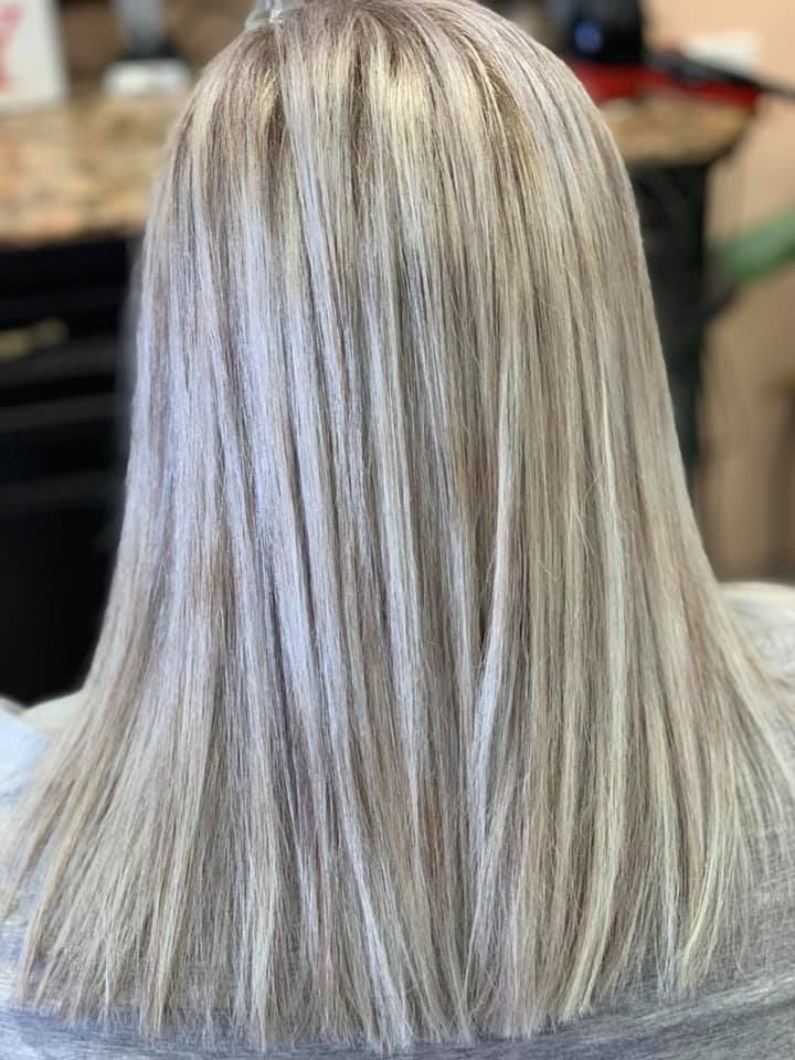 Blonde hair with highlights styled in a straight, shoulder-length cut.