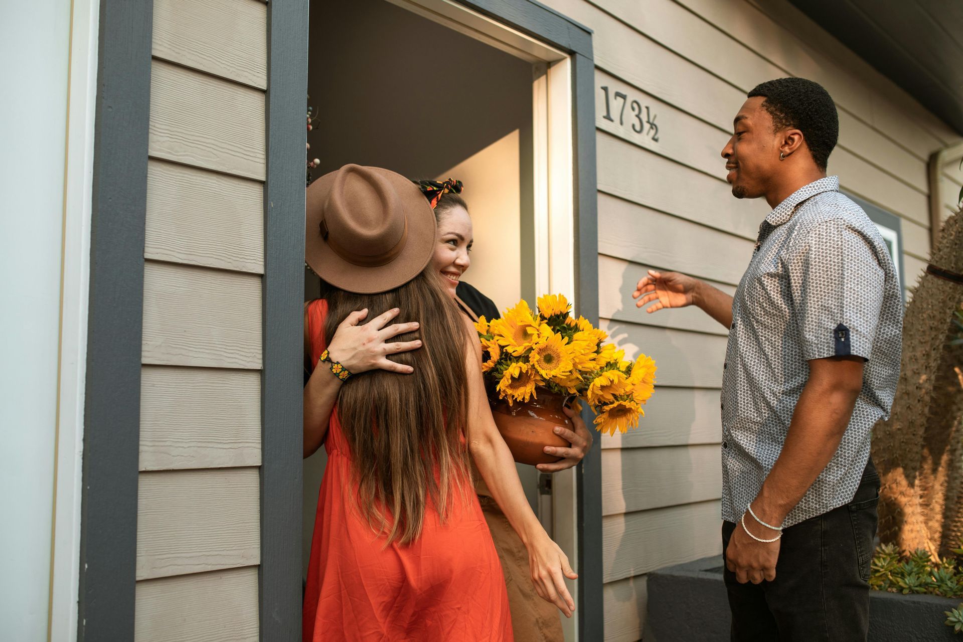 people hugging when entering house