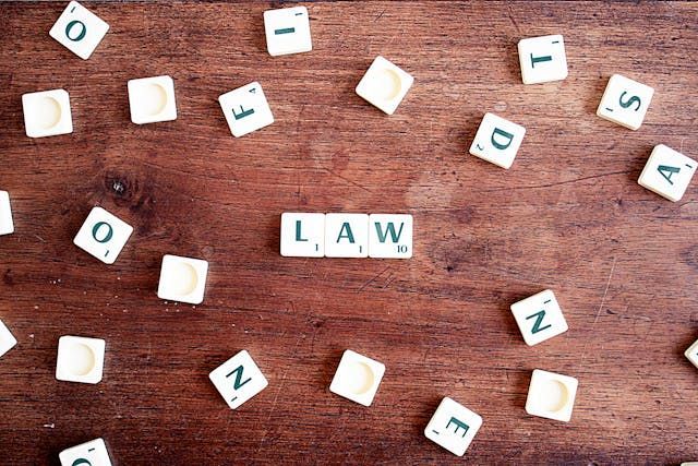 the word “law” spread out in Scrabble tiles