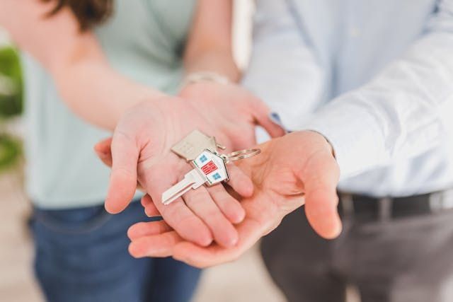 someone holding up house keys