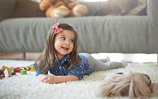 Girl Playing On A Carpet — Flooring Company in Gaithersburg, MD