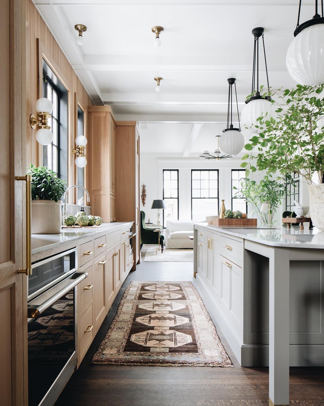 A kitchen with wooden cabinets and a rug on the floor