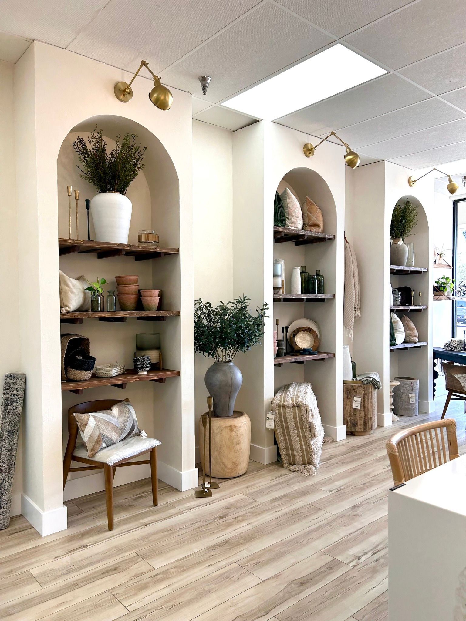 A room with a lot of shelves and potted plants