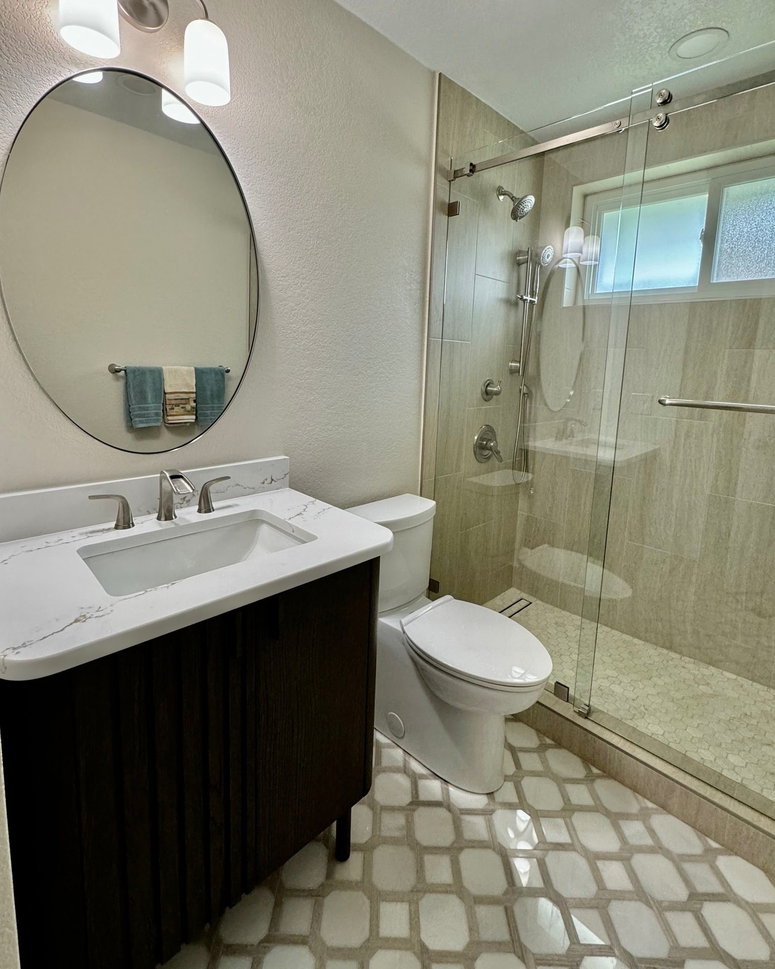 A bathroom with a toilet a sink and a mirror
