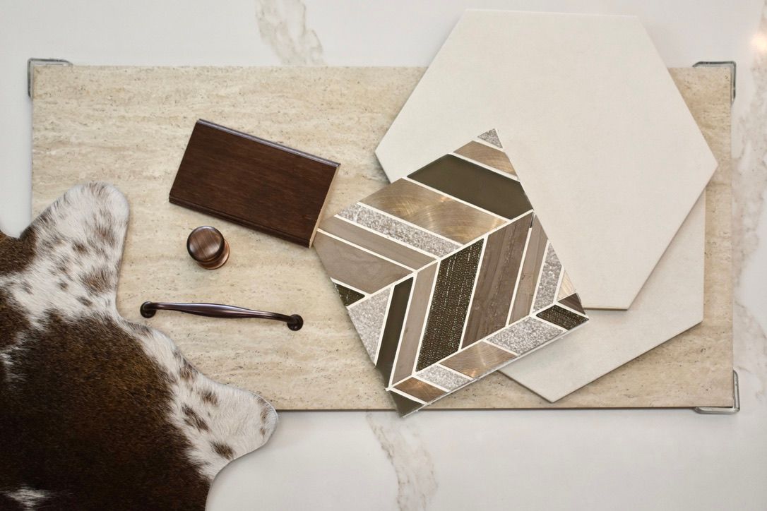 A dog is laying on a rug next to a selection of tiles.