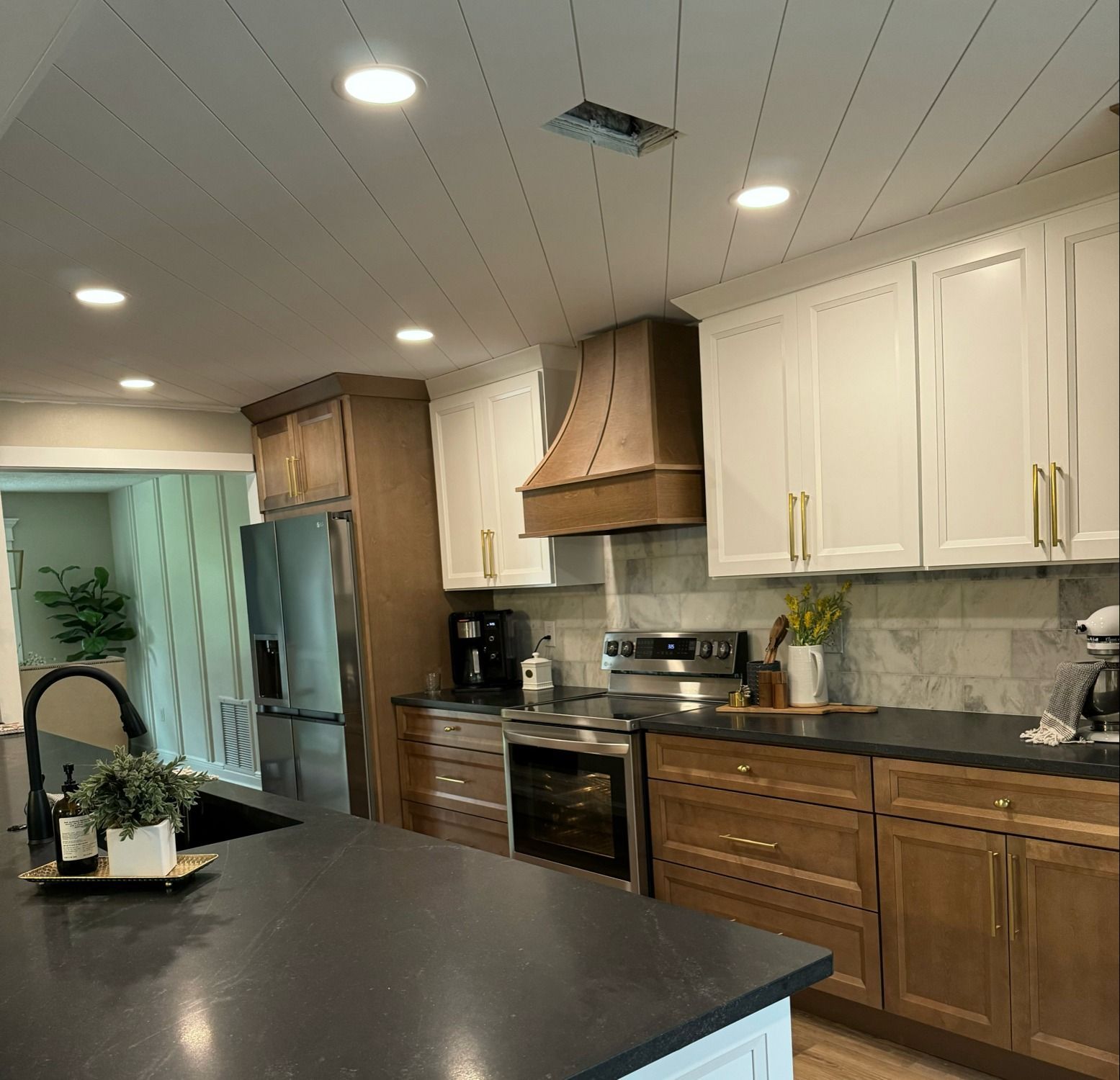 A kitchen with wooden cabinets and stainless steel appliances