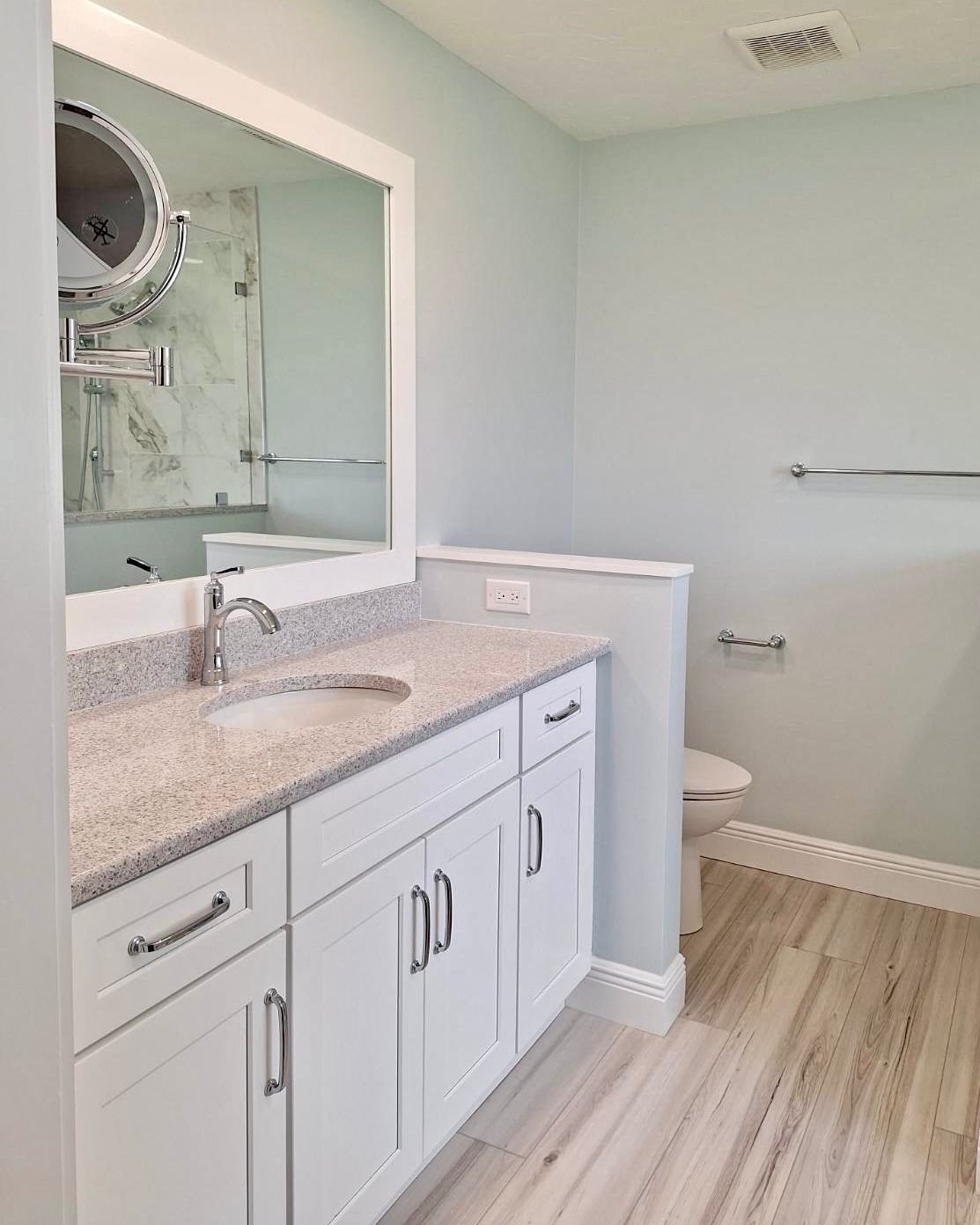 A bathroom with a sink , toilet , and mirror.