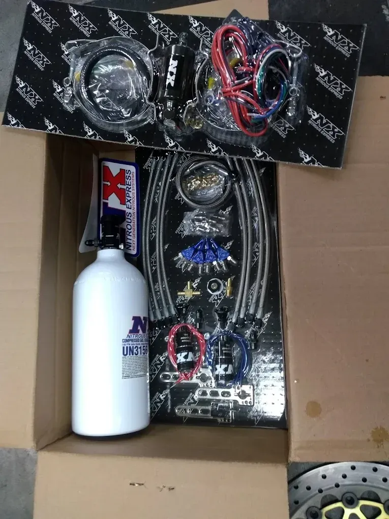 A box with a bottle of nitrous oxide in it
