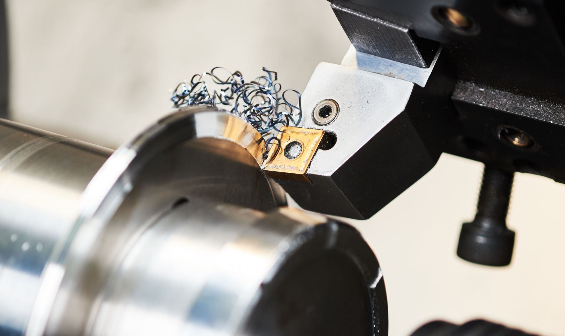 A machine is cutting a piece of metal on a machine.