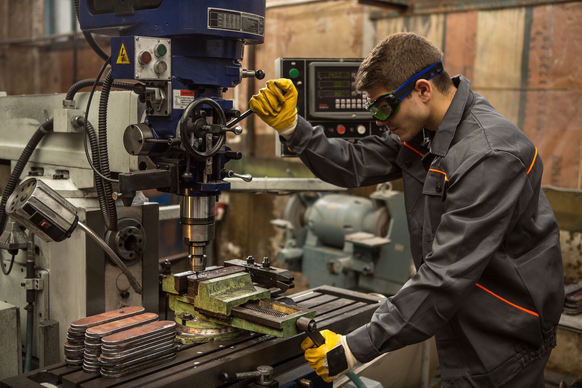 A man is working on a machine in a factory.