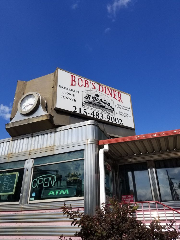 Bob 's diner is a diner with a clock on top of it.