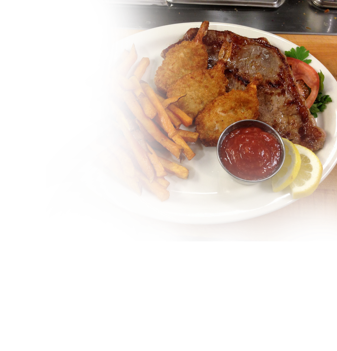 A white plate topped with fried food and french fries.