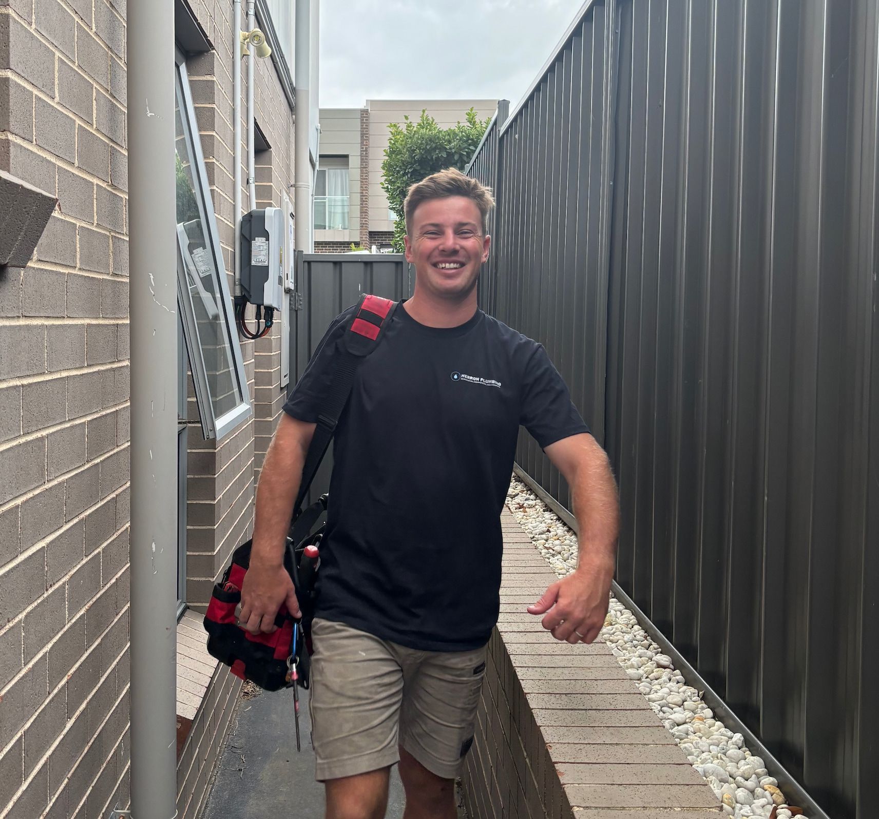 A Plumber is Working on a Pipe With a Pair of Pliers — Herron Plumbing in Flinders, NSW