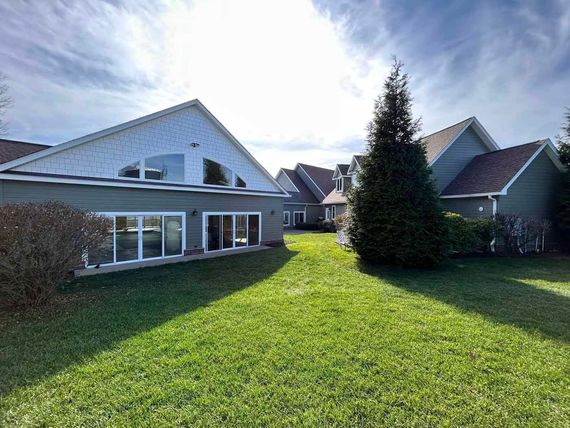 A large house with a large lawn in front of it.