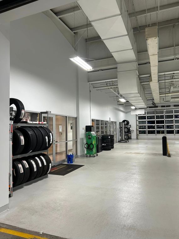 A large garage with a lot of tires on shelves.