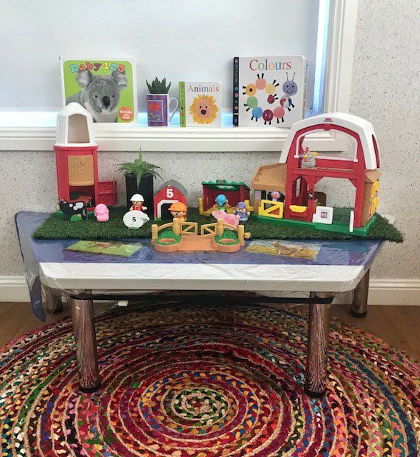 Purple Koalas Table With Toys And Books — Early Childhood Education in Central Coast, NSW